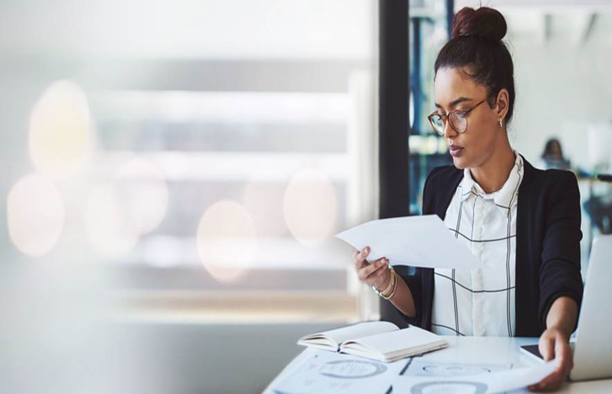 Woman looking at paperwork - Unpaid Wages